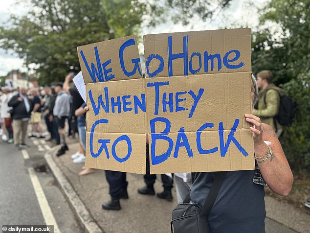 'We go home when they go back' reads this sign held outside the hotel yesterday evening
