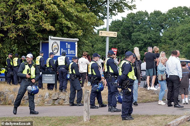 Dozens of officers were seen standing close to the protesters with riot helmets in their hands yesterday