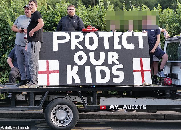 A sign displayed outside the hotel in reads 'Protect our Kids' with England flags painted on either side