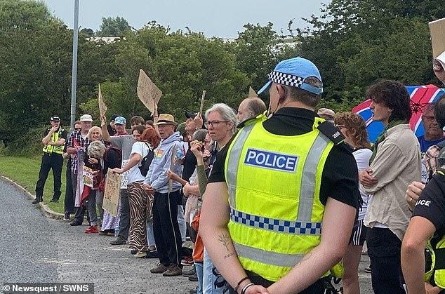 Demonstrators holding placards with messages reading 'Muslims welcome here' butted heads with protesters waving Union Jack flags with messages reading 'No to the mosque' and 'Not racist! Just patriotic!'