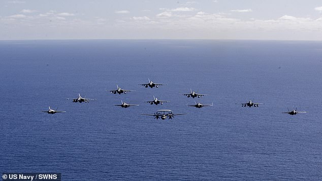 It also comes amid mounting fears that China is planning to launch a full-scale invasion of the island, with Beijing 's military having already drilled huge D-Day style assaults of Taiwan using soldiers, marines, warships and its air force. Pictured: U.S. Navy aircraft, attached to Carrier Air Wing (CVW) 5