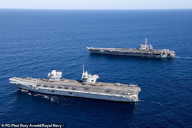 The 65,000-tonne leviathan - the biggest warship ever built for Britain (front) - sailed alongside the large US nuclear-powered aircraft carrier (back) as part of Talisman Sabre 2025