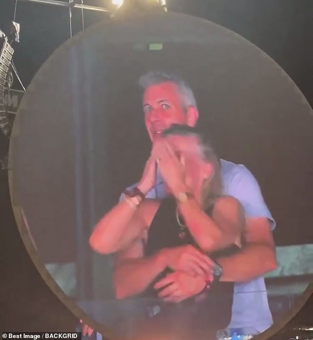 The two are seen looking stunned after realizing the camera was on them during the show