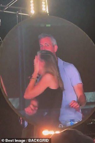 When they popped up on the concert's kiss camera, the pair immediately ducked and turned around in a desperate bid to hide their faces from the big screen