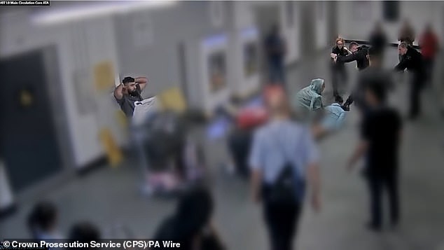 Moments later Muhammad Amaad sits with his hands behind his head after being Tasered by PC Marsden.