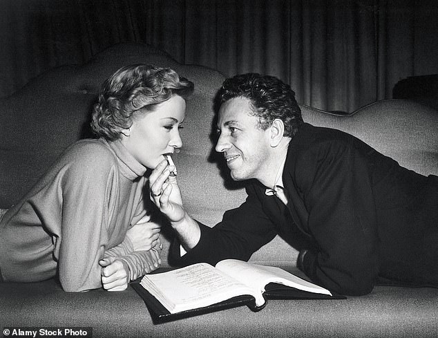 Graham and Ray share a cigarette while working on 1950 film In A Quiet Place, a year before he allegedly found the actress in bed with his teenage son Tony