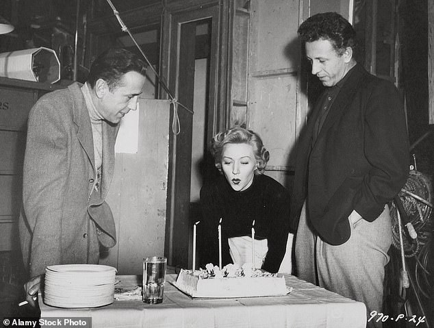 Her film credits included a starring role alongside Humphrey Bogart in Nicholas Ray's 1950 film In A Lonely Place (L-R: Bogart, Grahame and Ray are pictured on set)