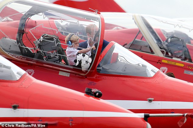 William talks to George as the stand in front of the RAF Arrows aircraft, during a visit to the Royal International Air Tattoo at RAF Fairford - the world's largest military airshow in July 2016