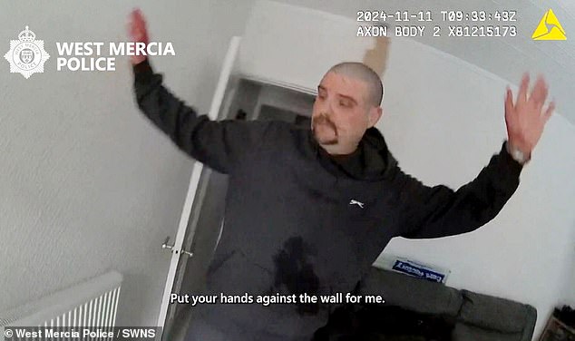 He holds up his hands with both covered in what appears to be Ms McKenna's blood
