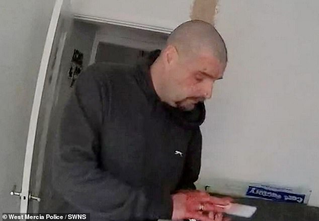 West Mercia Police said emergency services 'rushed to the address where efforts were made to save Cheryl's life'. Pictured: Hemming looks down at his phone with blood on his hands moments before his arrest