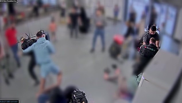Mohammed Fahir Amaaz (pictured left in blue) throws punches at PC Ellie Cook while his brother Muhammad Amaad (right, in black) grapples with her colleague PC Zachary Marsden