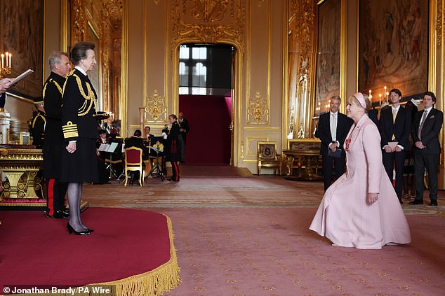 Lancashire's husband Peter Salmon watched from the sidelines as she obeyed strict royal protocol by curtsying before the Princess before receiving her medal