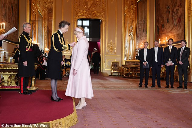 Family members looked on as the CBE was pinned to Lancashire's lapel on Tuesday