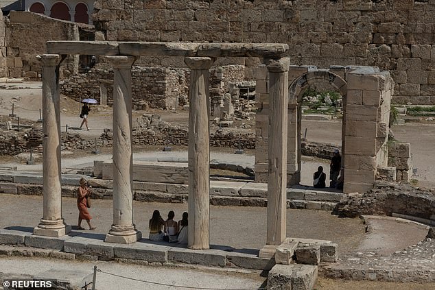 Tourists visit the Hadrian's Library archaeological site, during a heatwave in Athens, Greece, July 22, 2025