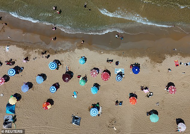 A drone view shows people enjoy a sunny day on a public beach in Kilyos, a coastal district of Istanbul along the Black Sea, Turkey, July 22, 2025