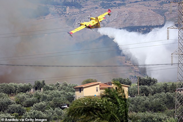 A water-dropping aircraft deploys over Sicily