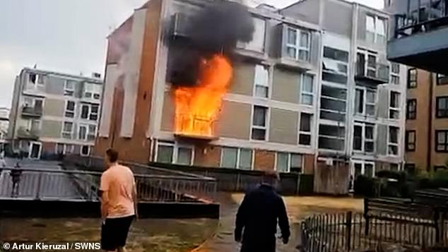 Footage showed the balcony of a flat totally destroyed by the fire and clouds of grey smoke billowing upwards while locals stood and watched on in horror