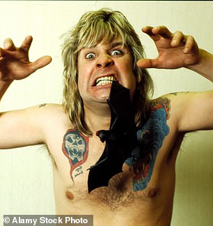 The singer posing with a fake bat between his teeth