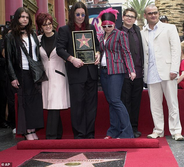 The late singer poses with his family during a ceremony on April 12, 2002, in Los Angeles. Pictured with Osbourne, from left, are Aimee, Sharon, Kelly, Jack and Louis
