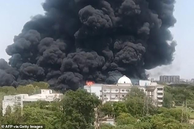 Pictured: Thick black smoke billowing from a residential area after Air India flight 171 crashed in Ahmedabad