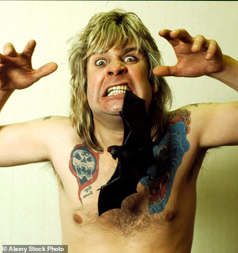 The singer posing with a fake bat between his teeth