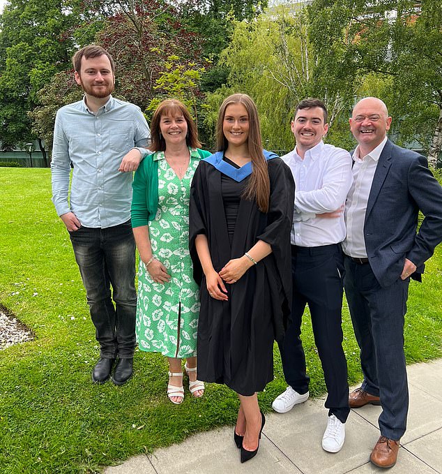 The father-of-three pictured, far right, with his family at his daughter's graduation. The painful kick many years ago prompted him to have his testicles checked out, revealing he had cancer