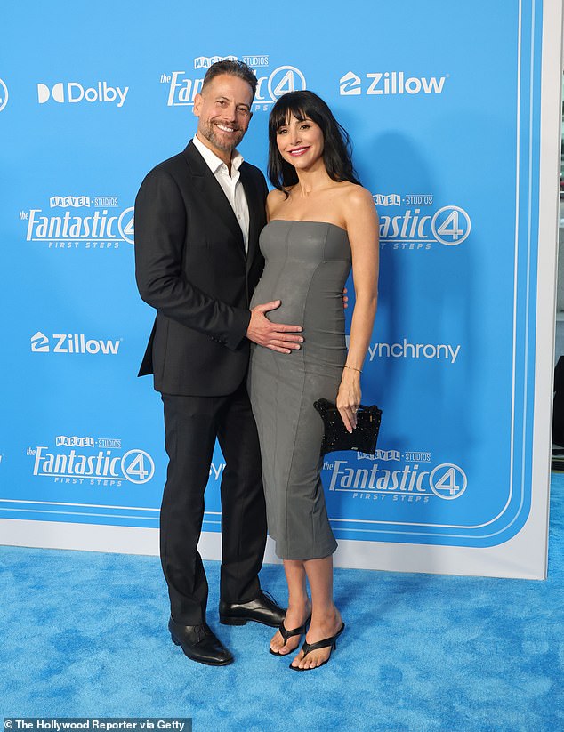 The Welsh actor, 51, looked every inch the proud father-to-be as he tenderly cradled his new wife's growing baby bump while posing on the blue carpet