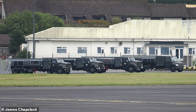 US servicemen were seen moving huge petrol tankers, possibly used to refill Air Force One and walking around the tarmac at Prestwick Airport amid the huge security operation