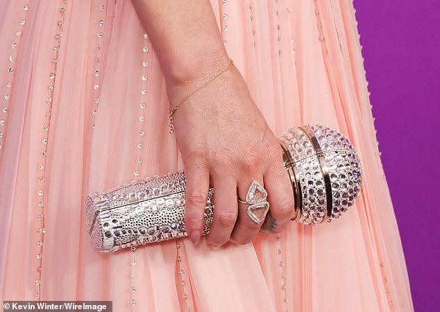 She toted a bedazzled microphone as a nod to her character's fictional band Pink Slip, which dropped a new version of Take Me Away on July 11