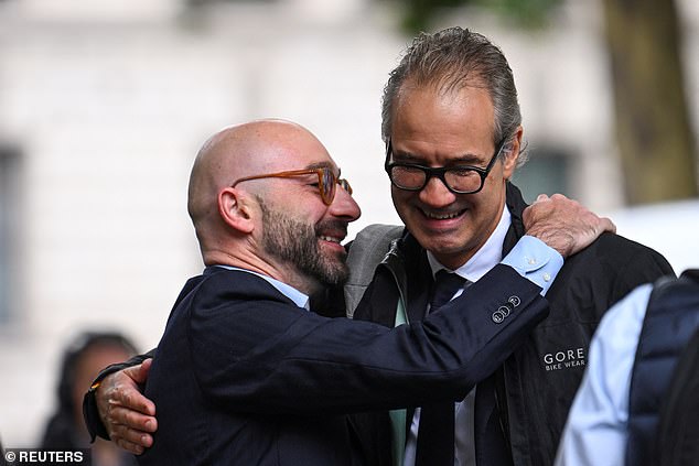 Carlo Palombo, ex-vice president of euro rates at Barclays, hugs a man outside court today
