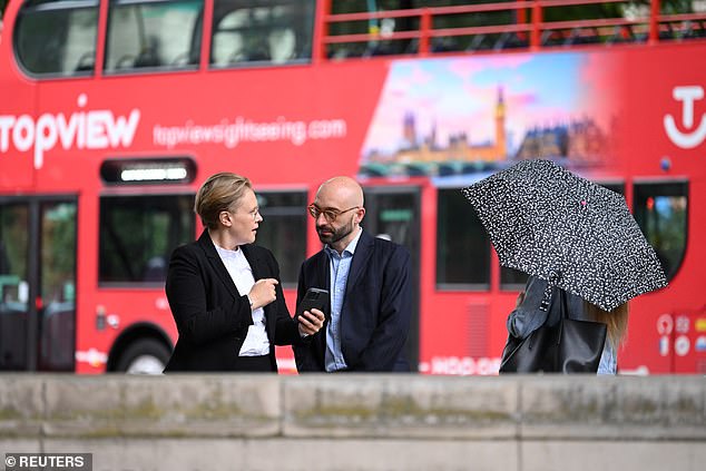 Former Barclays trader Carlo Palombo speaks with a member of his legal team in London today