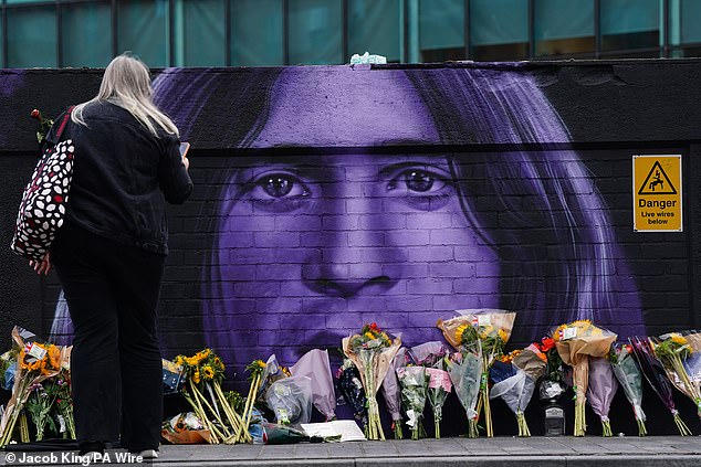 Floral tributes are left by the Sabbath Wall in Navigation Street in Birmingham on Wednesday