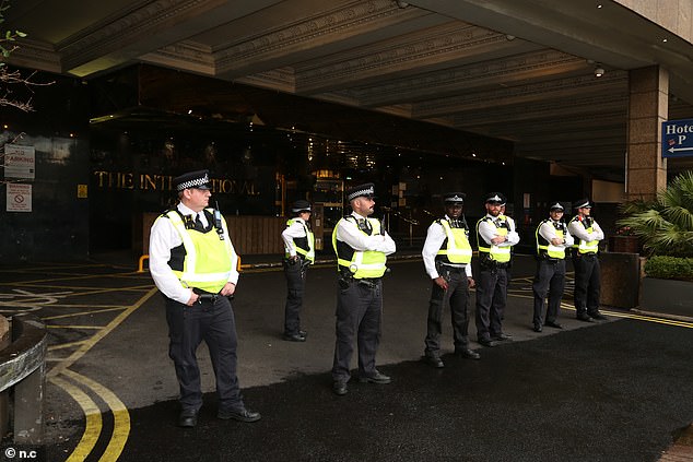 A row of police officers were seen blocking the entrance to the Britannia International Hotel