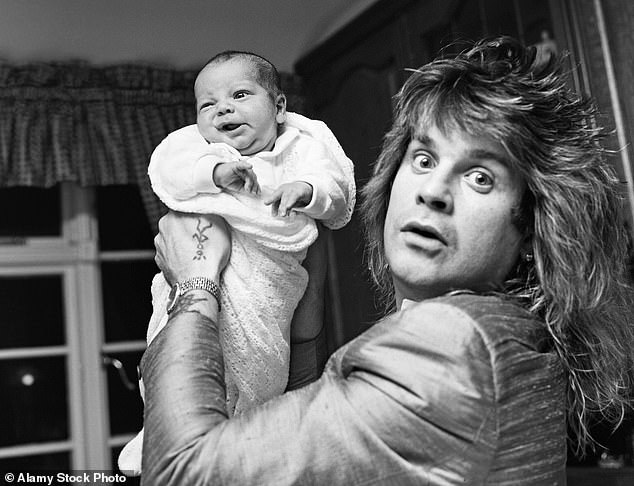 Ozzy at home his youngest child, Jack, just two weeks after his birth in 1985