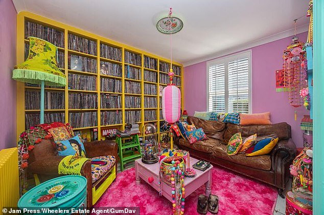 Sitting room: The bight pink carpet and the yellow book shelf are found to wake you up in the morning