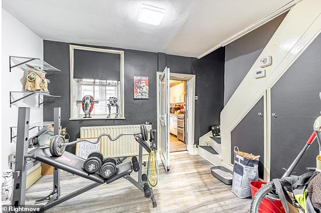 The 872 sq ft house also currently has a gym by the stairs with a bench, a barbell and some dumbbells - along with an array of Star Wars figurines