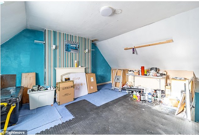 The attic bedroom appears to be undergoing decorating and has been painted a stripy blue colour