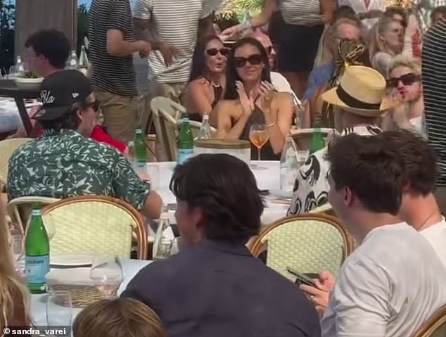 New footage has shown the music legend sitting down for lunch with his godson (seen far left), after sources revealed he 'said his piece' about his feud with his parents