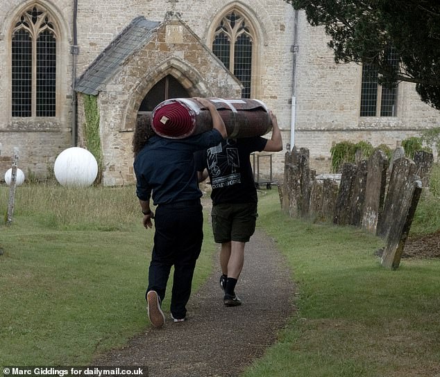 Staff were seen working around the clock today at the 12th Century Norman church in the Cotswolds village of Great Tew that will be the setting for Apple heiress Eve Jobs' wedding