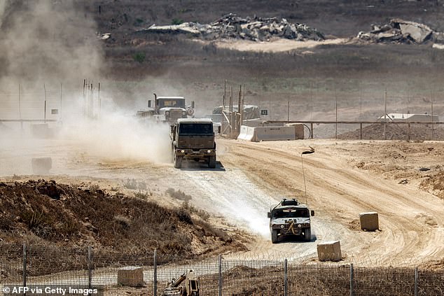 World leaders have urged Israel to end its military campaign in Gaza 'now' (pictured: military vehicles on the border earlier today)