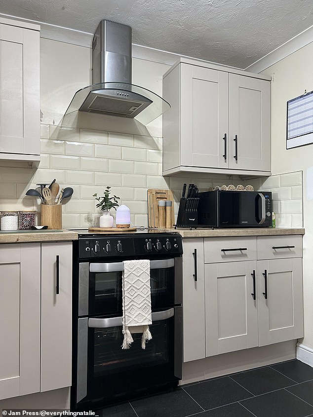 She lightened up the room by adding a lick of cream paint to her cupboards and changed the appearance of the counter tops with some vinyl