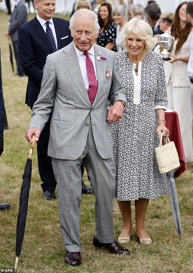 Britain's King Charles III (L) and Britain's Queen Camilla (R) arrive during their visit to the Sandringham Flower Show