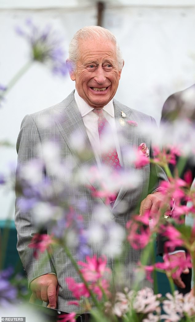 The King beamed as he was given a tour of the flowers on display