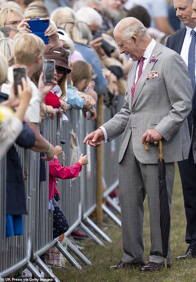 The royal couple greeted queuing crowds as part of a walkabout on Wednesday