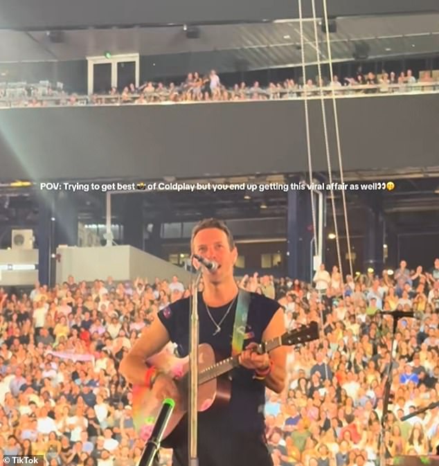 A new angle shows them entwined well before the Jumbotron incident. They are visible in the top stood up while everyone around them remains sat