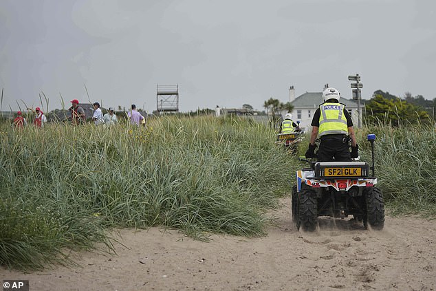 Police on buggies patrol near the Trump Turnberry golf course as golfers play