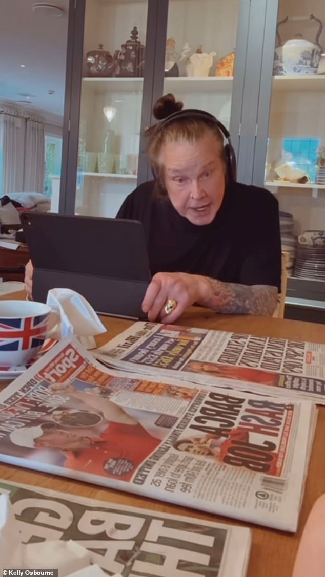 Kelly said: 'Good morning', before panning the camera to her father who was wearing a pair of headphones as she said, 'Dadda, say good morning', he replied 'Good morning!'