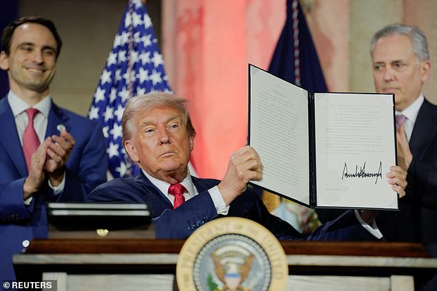 President Donald Trump holds an executive order related to AI after signing it during the "Winning the AI Race" Summit i