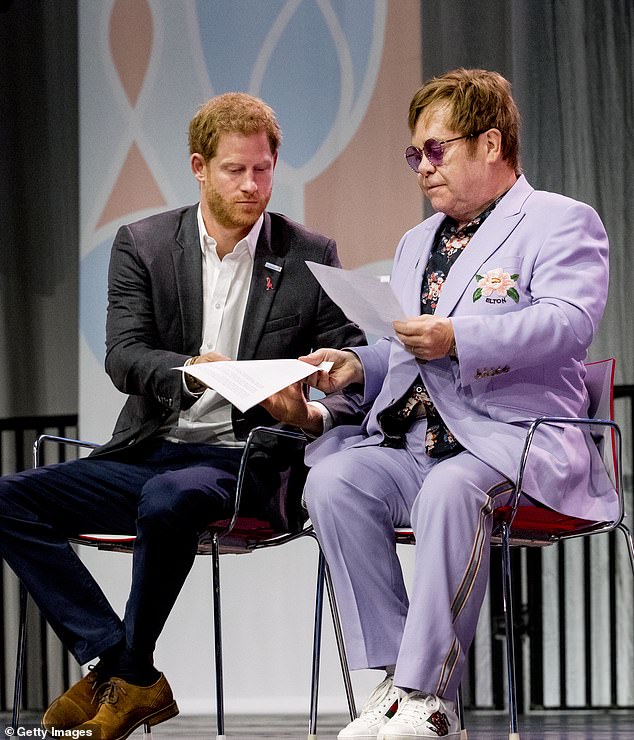 Throughout the years, Elton has reportedly made an effort to speak to the Duke and Duchess of Sussex 'every day' and is 'very protective of them both' (pictured with Harry in 2018)