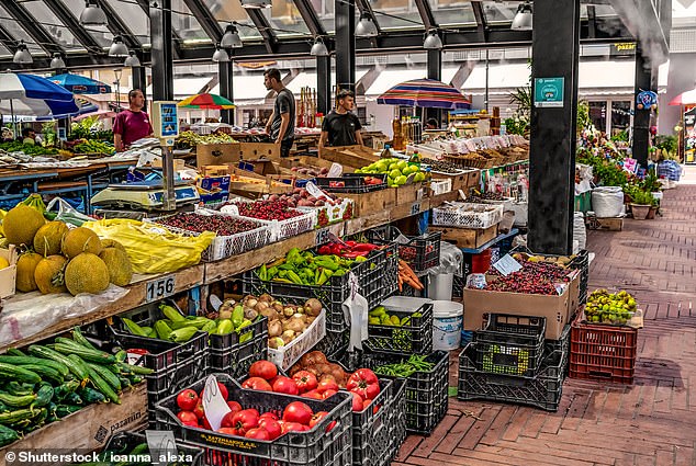 She often spends her time touring agrotourism farms and wineries in the countryside, where she indulges in fresh cheese and seasonal wine (Pictured: Pazari i Ri market in Tirana)